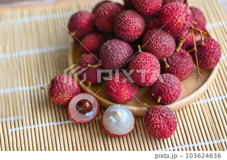 fresh ripe lychee fruit tropical fruit peeled lychees slice in Thailand, lychees on wooden plate 103624636