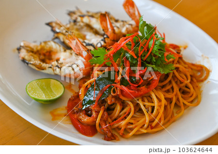 noodles plate with spaghetti pasta stir fried with vegetables herb spicy tasty appetizing asian noodles mix seafood stir fried shrimp squid shellfish fish with basil and chilli pepper noodles plate with spaghetti pasta stir fried with vegetables herb spicy tasty appetizing asian noodles mix seafood stir fried shrimp squid shellfish fish with basil and chilli pepper 103624644