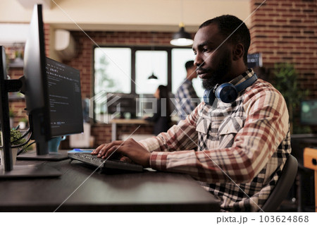 Freelance coder typing javascript code on computer to develop online cloud computing information. Software developer writing html script and data algorithm, working in it programming office 103624868