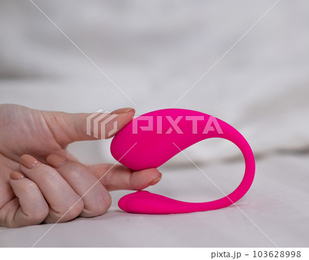 Woman holding curved pink vibrator while lying... - Stock Photo [103628998]  - PIXTA