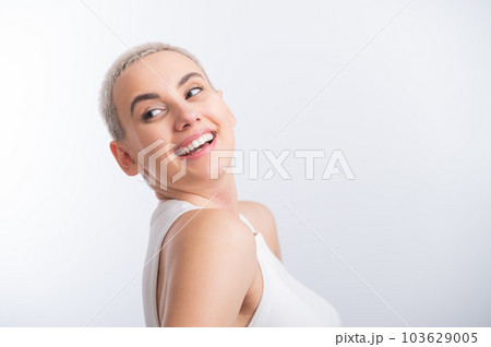 Beautiful young caucasian woman with a short haircut on a white background. Beautiful young caucasian woman with a short haircut on a white background. 103629005
