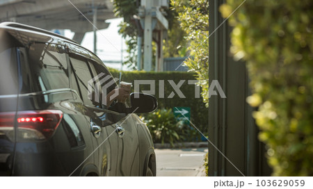 Hand Man in car receiving coffee in drive thru fast food restaurant.  103629059