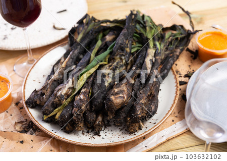 A traditional catalan dish of charred calcot onion and romesco sauce A traditional catalan dish of charred calcot onion and romesco sauce 103632102