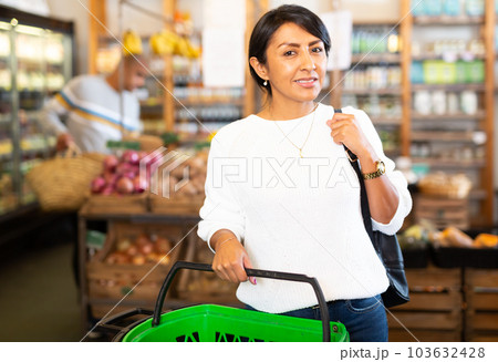 Positive woman in grocery store interior 103632428