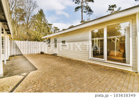 a house that is in the process of being remodeled and renovated with new siding, brick paversing and white trim a house that is in the process of being remodeled and renovated with new siding, brick paversing and white trim 103638349