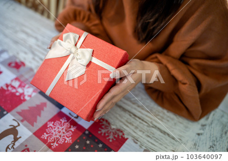 Happy excited asian woman hands holding Christmas gift box. cheerful girl packing Xmas present or open box xmas new year birthday gift. Happy excited asian woman hands holding Christmas gift box. cheerful girl packing Xmas present or open box xmas new year birthday gift. 103640097
