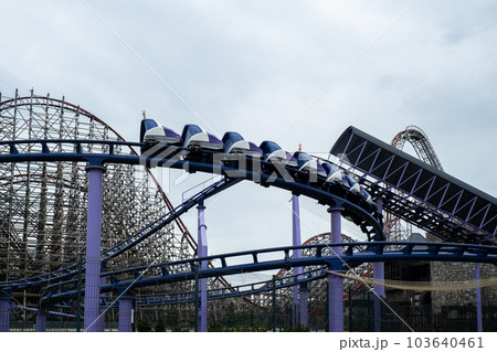 Riding the roller coaster at Energylandia Zator Poland amusement park. Solar powered roller coaster. Rollercoaster against blue sky Wooden outdoor leisure family 103640461