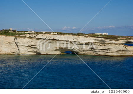 DELIMARA, MARSAXLOKK, MALTA - 03 JAN, 2020: coast and shoreline of a small bay in Delimara Malta, with blue turquoise sea in summer Sunny day with blue sky and lime stone coast along the Mediterranean 103640900
