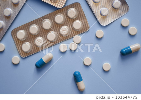 pills and pill packs on a blue background, medication, medical workers day, medical care, banner for the hospital pills and pill packs on a blue background, medication, medical workers day, medical care, banner for the hospital 103644775
