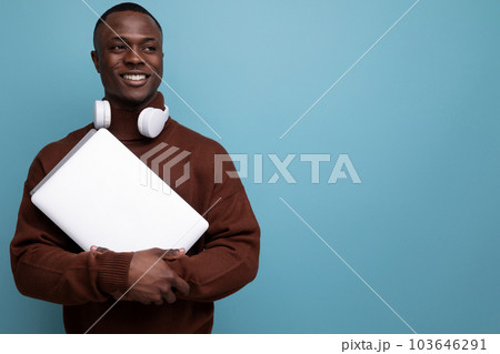 young american sound producer with laptop and headphones on background with copy space 103646291