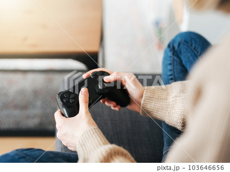 Girl playing on games console Girl playing on games console 103646656