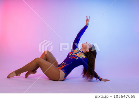 Full length teen girl smiling doing fitness exercises, isolated on white and dark background 103647669