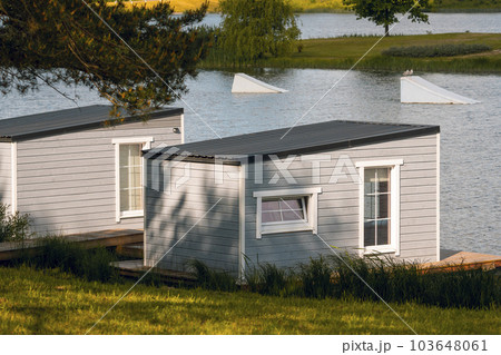 Overwater wooden bungalows on the lake with a wake park equipment 103648061