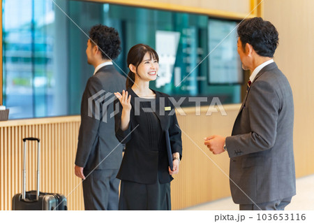 フロントで旅行客を接客する案内係の女性 フロントで旅行客を接客する案内係の女性 103653116