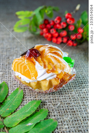 Fruit cake. Dessert tartlet with cream and fruit filled with sweet caramel. Fruit cake. Dessert tartlet with cream and fruit filled with sweet caramel. 103654064