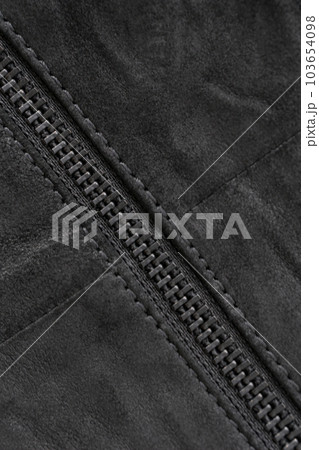 Crumpled black suede textured vertical background with black metal zip Crumpled black suede textured vertical background with black metal zip 103654098