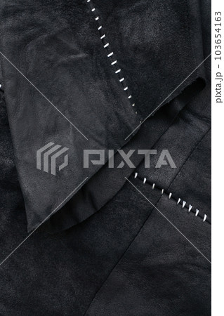 Sleeve detail of a black suede jacket with white contrast stitching Sleeve detail of a black suede jacket with white contrast stitching 103654163