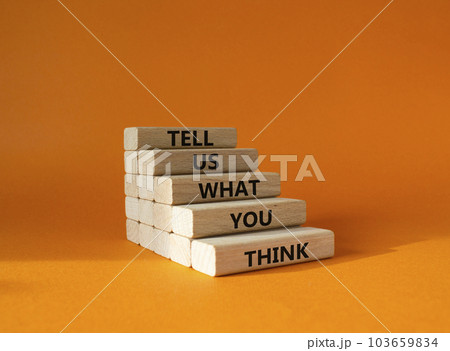 Tell us what you think symbol. Wooden blocks with words Tell us what you think. Beautiful orange background. Business and Tell us what you think concept. Copy space. 103659834