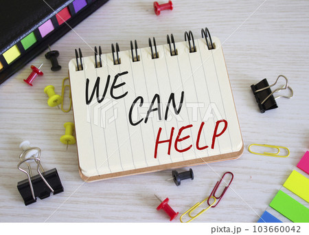 We can help symbol. Concept words We can help on white notebook. Beautiful wooden background. Business and We can help concept. Copy space. We can help symbol. Concept words We can help on white notebook. Beautiful wooden background. Business and We can help concept. Copy space. 103660042