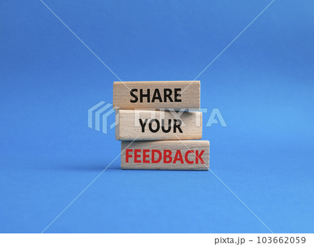 Feedback symbol. Concept word Share your feedback on wooden blocks. Beautiful blue background. Business and Ask for feedback concept. Copy space 103662059