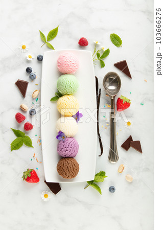Set of various ice cream scoops and ingredients on white marble background, top view 103666276
