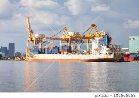 Cargo ship at dock with sky background. 103666965