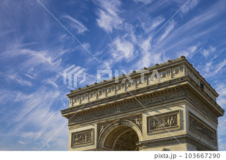 Arc de Triomphe (against the background of sky with clouds), Paris, France. The walls of the arch are engraved with the names of 128 battles and names of 660 French military leaders (in French) 103667290