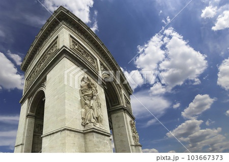 Arc de Triomphe (against the background of sky with clouds), Paris, France. The walls of the arch are engraved with the names of 128 battles and names of 660 French military leaders (in French) Arc de Triomphe (against the background of sky with clouds), Paris, France. The walls of the arch are engraved with the names of 128 battles and names of 660 French military leaders (in French) 103667373