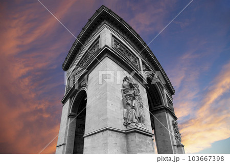 Arc de Triomphe (against the background of sky with clouds), Paris, France. The walls of the arch are engraved with the names of 128 battles and names of 660 French military leaders (in French) 103667398