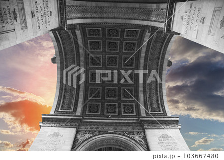 Arc de Triomphe (against the background of sky with clouds), Paris, France. The walls of the arch are engraved with the names of 128 battles and names of 660 French military leaders (in French) 103667480
