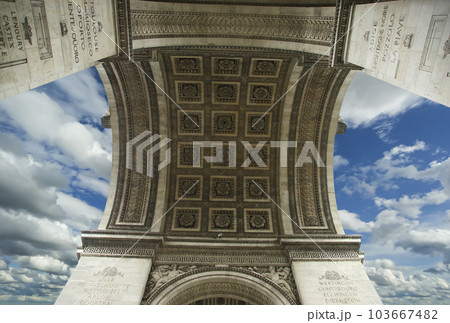 Arc de Triomphe (against the background of sky with clouds), Paris, France. The walls of the arch are engraved with the names of 128 battles and names of 660 French military leaders (in French) 103667482