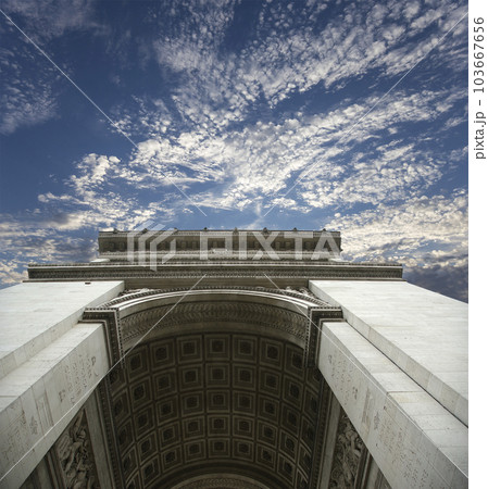 Arc de Triomphe (against the background of sky with clouds), Paris, France. The walls of the arch are engraved with the names of 128 battles and names of 660 French military leaders (in French) 103667656