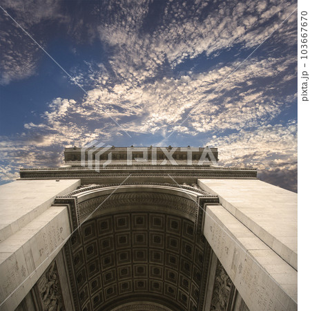 Arc de Triomphe (against the background of sky with clouds), Paris, France. The walls of the arch are engraved with the names of 128 battles and names of 660 French military leaders (in French) 103667670