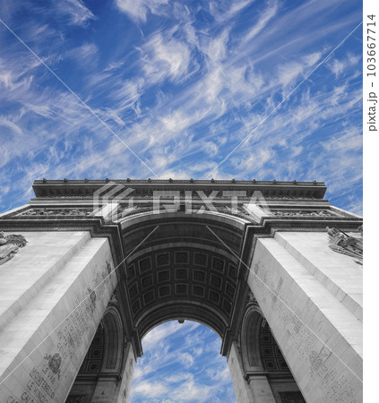 Arc de Triomphe (against the background of sky with clouds), Paris, France. The walls of the arch are engraved with the names of 128 battles and names of 660 French military leaders (in French) 103667714
