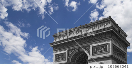 Arc de Triomphe (against the background of sky with clouds), Paris, France. The walls of the arch are engraved with the names of 128 battles and names of 660 French military leaders (in French) 103668041