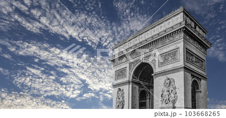 Arc de Triomphe (against the background of sky with clouds), Paris, France. The walls of the arch are engraved with the names of 128 battles and names of 660 French military leaders (in French) 103668265