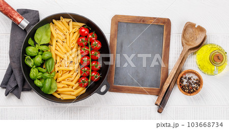 A vibrant representation of the Italian flag made with pasta, basil, and tomatoes 103668734