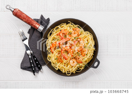 A delightful Italian pasta adorned with shrimps 103668745