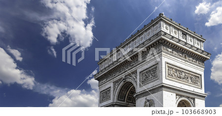 Arc de Triomphe (against the background of sky with clouds), Paris, France. The walls of the arch are engraved with the names of 128 battles and names of 660 French military leaders (in French) Arc de Triomphe (against the background of sky with clouds), Paris, France. The walls of the arch are engraved with the names of 128 battles and names of 660 French military leaders (in French) 103668903