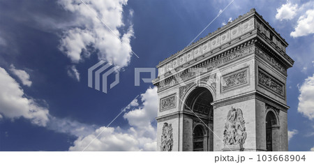 Arc de Triomphe (against the background of sky with clouds), Paris, France. The walls of the arch are engraved with the names of 128 battles and names of 660 French military leaders (in French) Arc de Triomphe (against the background of sky with clouds), Paris, France. The walls of the arch are engraved with the names of 128 battles and names of 660 French military leaders (in French) 103668904