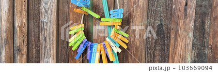 colorful clothespins hang on a wooden fence colorful clothespins hang on a wooden fence 103669094