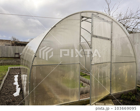 polycarbonate greenhouse is ready for use in early spring in the garden polycarbonate greenhouse is ready for use in early spring in the garden 103669095
