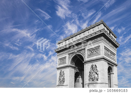 Arc de Triomphe (against the background of sky with clouds), Paris, France. The walls of the arch are engraved with the names of 128 battles and names of 660 French military leaders (in French) 103669183