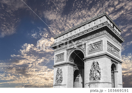 Arc de Triomphe (against the background of sky with clouds), Paris, France. The walls of the arch are engraved with the names of 128 battles and names of 660 French military leaders (in French) 103669191