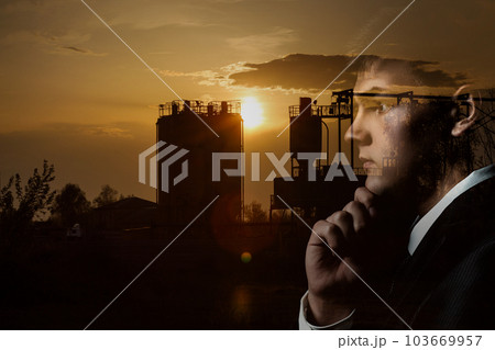 A man thinking in front of a factory. A man thinking in front of a factory. 103669957