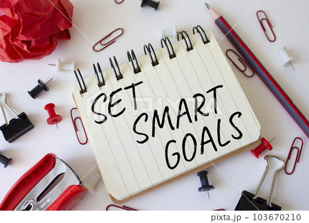 Set smart goals symbol. Concept words Set smart goals on white notebook. Beautiful wooden background. Business and Set smart goals concept. Copy space. Set smart goals symbol. Concept words Set smart goals on white notebook. Beautiful wooden background. Business and Set smart goals concept. Copy space. 103670210