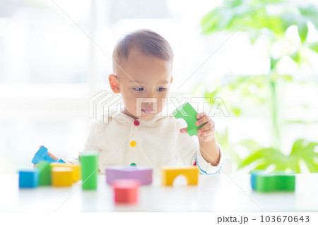 Baby boy playing with toy Baby boy playing with toy 103670643