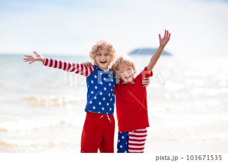 Kids with American flag on beach. 4th of July. 103671535