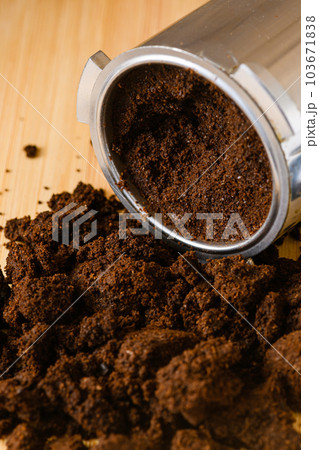 Spent or used coffee grounds with portafilter. Spent or used coffee grounds with portafilter. 103671838