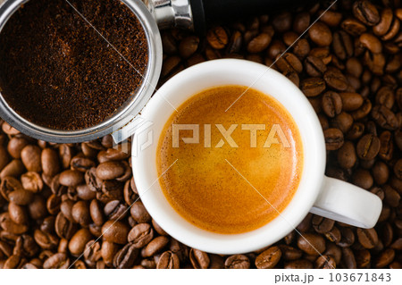 Spent or used coffee grounds with holder and a cup of freshly brewed coffee 103671843